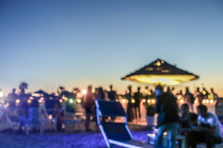 group partying on a beach florida charter bus company