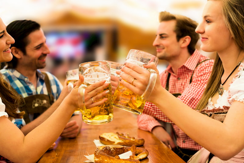 friends toast and enjoy a few beers at Oktoberfest in Lantana
