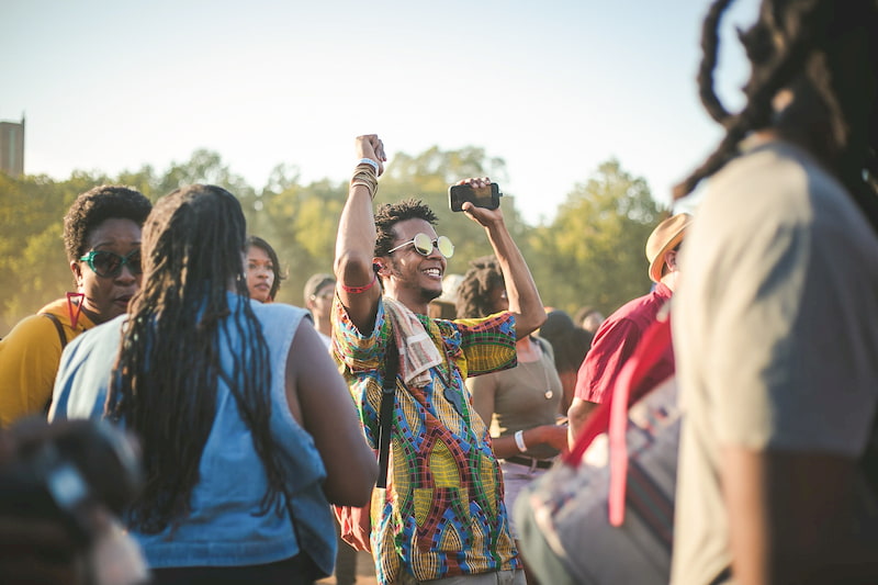 man dances in a festival crowd