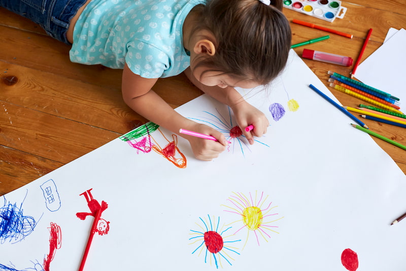 a child leans in on an art project at the crayola experience in orlando, florida