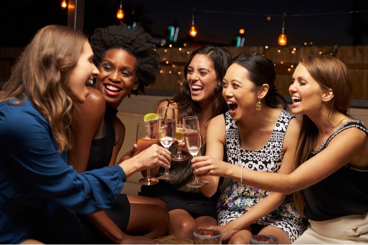 group of women enjoying drinks at an event