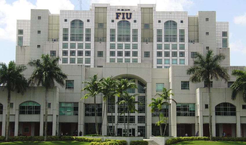 academic building at florida international university surrounded by palm trees