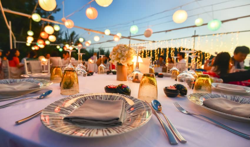 A set table with string lights during a wedding reception