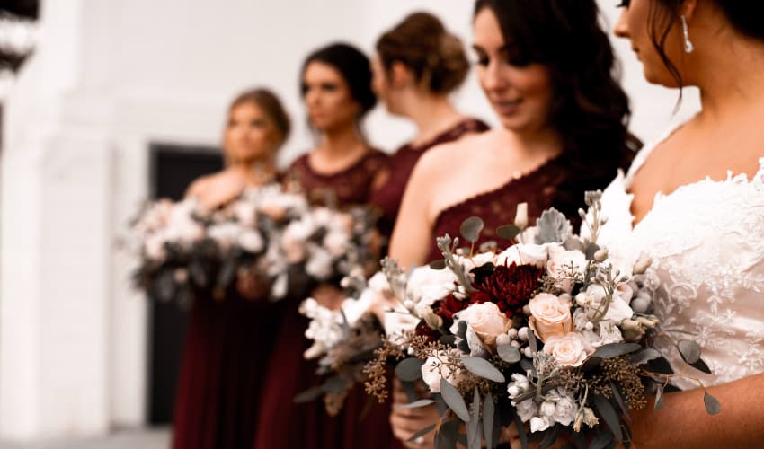 A bride and bridesmaids holding bouquets of flowers