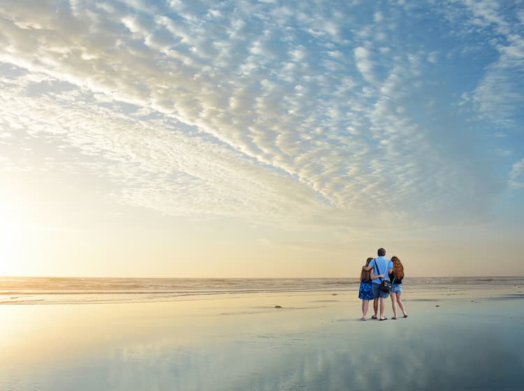 Family enjoying time on the beach in Jacksonville, Florida at sunrise