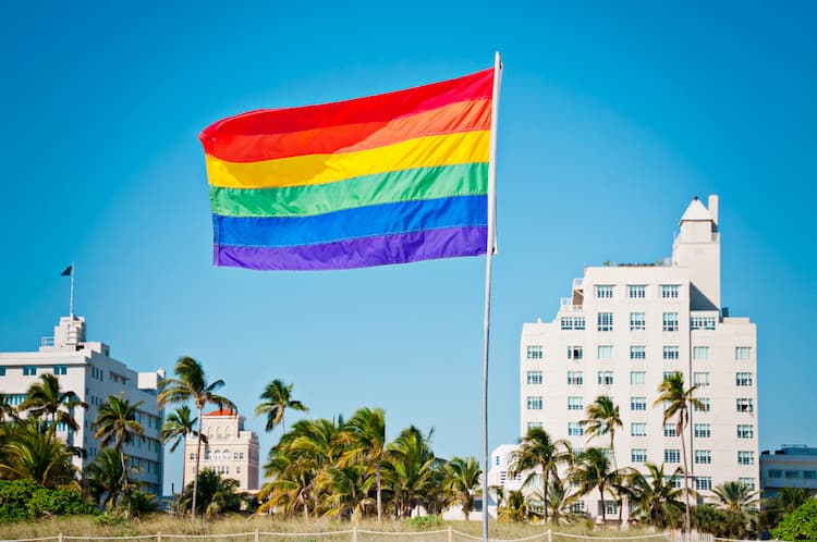 Rainbow flag in front of buildings in Miami Beach