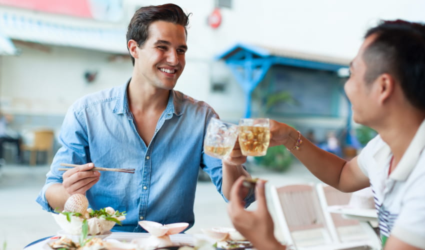 two men enjoy brunch in a restaurant setting