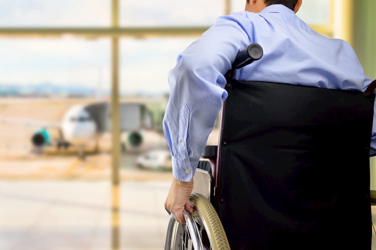 Businessman using wheelchair at airport