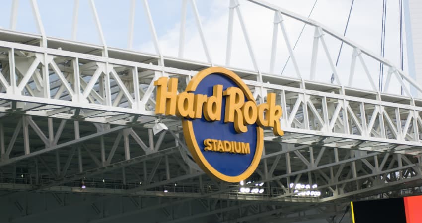 A closeup of the logo of the Hard Rock Stadium in the rafters of the football stadium
