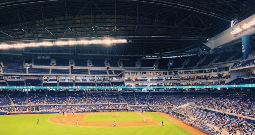 A photo inside Marlins Park during a baseball game, looking out over the outfield and across the stands full of fans
