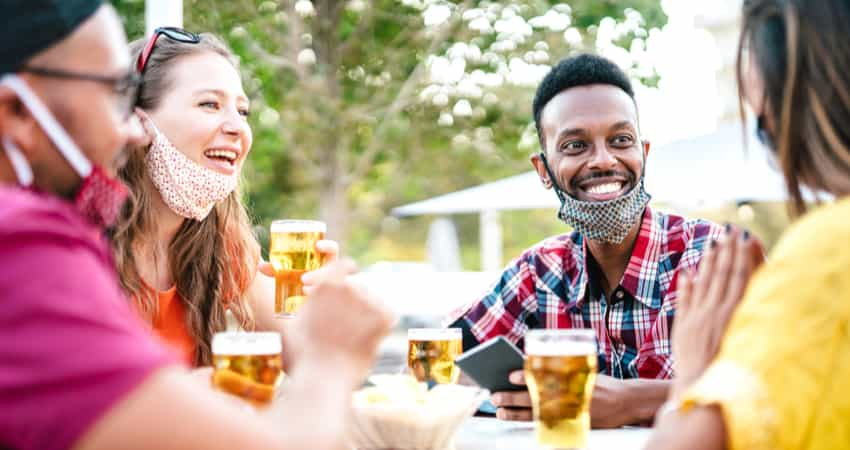 A group of friends sitting outside at a brewery