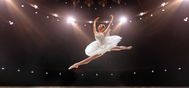 a ballerina jumps in the air and splits her legs