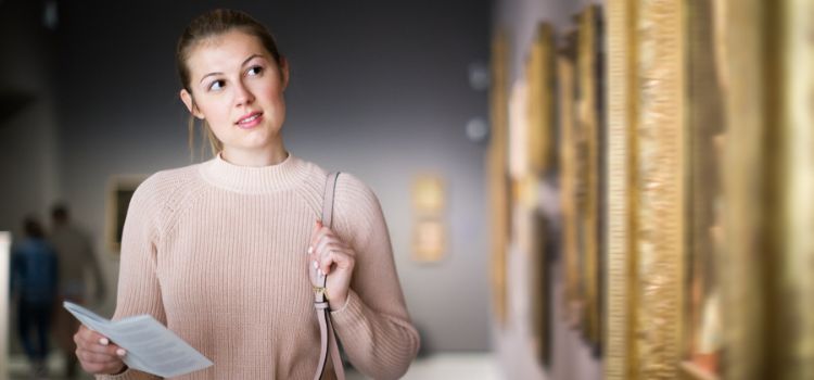woman browsing art at a history museum