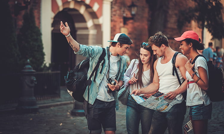 A group of tourists consult a map in a historic city