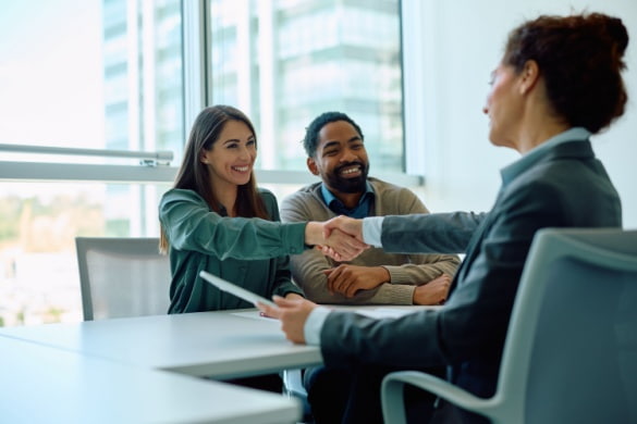 coworkers shaking hands in a meeting room