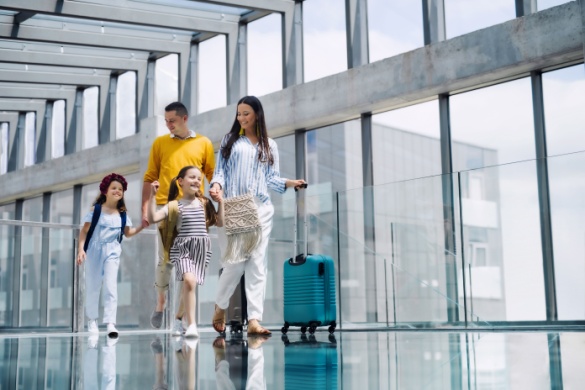 a family walks happily through the airport