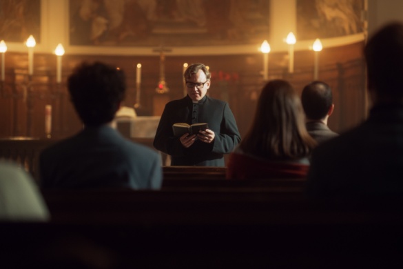 a pastor leads his congregation in prayer