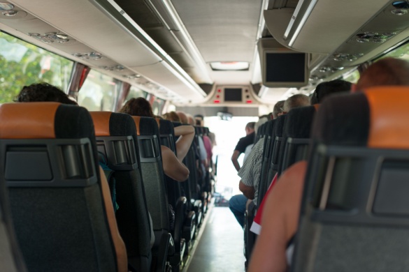 a large tour group sits comfortably on a charter bus